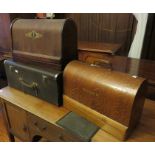 A group of three sewing machines, two Singers (one with original mat) in wooden cases and one in a