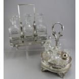 A Victorian three-decanter set in a fine plate holder with carrying handle and lion-head mounted