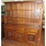 An early twentieth century oak dresser with plate rack, drawers and cupboards. 168 cm wide, 183 cm