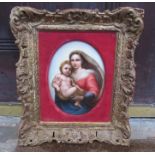 A continental, probably German hand-painted porcelain plaque depicting mother and child in a gilt