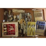 A large quantity of cutlery to include sets of spoons, forks, knifes, some in presentation boxes. (