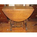 A small-size oak gate leg table with drop leaf with barley twist spindles. 72cm wide.