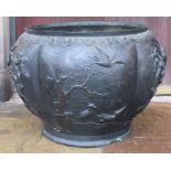A large Japanese bronze-type jardiniere with clouds around the rim and panels of birds, including