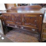 An oak side board with two doors and drawers. 135 cm wide.