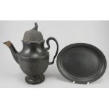 An early nineteenth century black basalt coffeepot and cover and a similar teapot stand, c.1810.