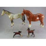 Four Beswick pottery horses including two foals.  Large horse with chip to foot and body crack