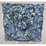 A 20th Century Chinese blue and white square tile, a central roundel framed by scrollwork, 19.5cm