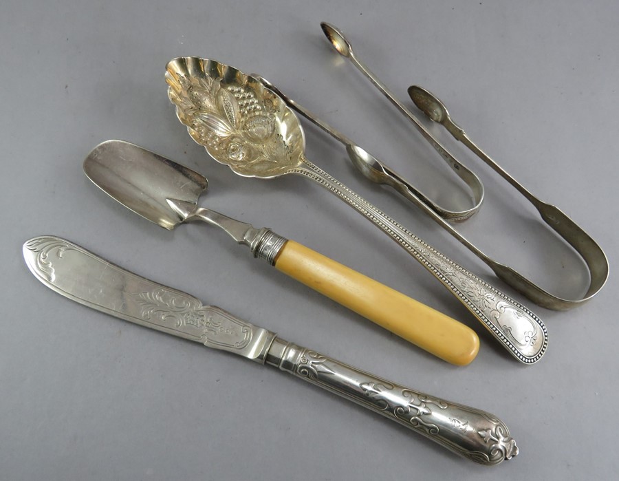 A small group of hallmarked silver to include: a knife, scoop, spoon and two pairs of tongs. 320g