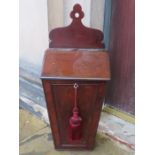 A mid-nineteenth century mahogany hanging candle box of tapered coffin form. 53 cm tall.