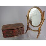 A small child's toy painted two-drawer chest of drawers and a similar swing mirror. 23 cm wide. (