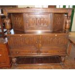 A large nineteenth century oak court cupboards in three sections. 153 cm wide.