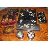 A group of eight black lacquered papier mache pieces to include boxes, a handled tray and a