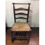 A 19th Century ash rush seated ladder back rocking chair, circa 1850