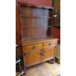 An early twentieth century oak dresser of small proportions. Plate rack to the top and two drawers