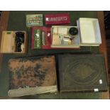 Two bibles, a boxed microscope, playing cards, draughts, a harmonica and two playing boards.