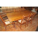 An early twentieth century oak dining table and six chairs, two of which are carvers. Table: 183