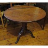 A nineteenth century oak tilt-top circular table. 76 cm wide.  Tilt not working.