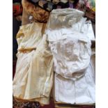 A box of vintage baby clothes including cotton nightdress and underskirts from Mid Victorian to