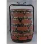An oriental black lacquer four section lidded stor