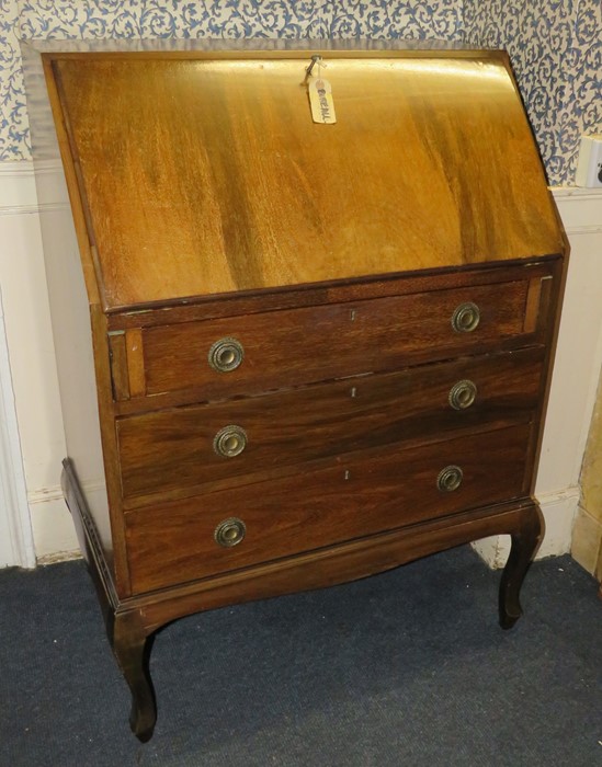 An early twentieth century mahogany bureau with folding writing section, on cabriole legs.