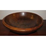 An eighteenth century large sycamore wooden dairy bowl, c. 1790. 56 cm wide.  Crack in the rim.