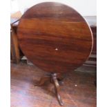 A Victorian walnut circular tilt-top table. 87cm wide.