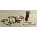 A small group of silver items: a napkin ring, scent bottle, a penknife with mother of pearl