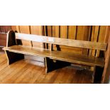 A 20th Century oak church pew. 229cm L Provenance: