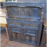 An early twentieth century oak court cupboard with carved details. 109 cm wide.