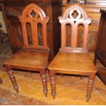 A pair of nineteenth century oak hall chairs Litchfield Cathedral. 85 cm tall. (2)