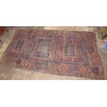 A nineteenth century rug, possibly Persian. 240cm long.  Condition: Wear, damage and repaired.