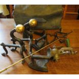 A group of metal ware ti include: a food mincer, two fire dogs, a brass poker, a shoe last and