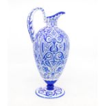 A blue and white glass ewer