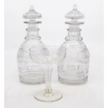 A pair of decanters, star cut bases; and a drinking glass (3)