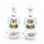A pair of Meissen style twin handled vases with stoppers, approx 20cm high