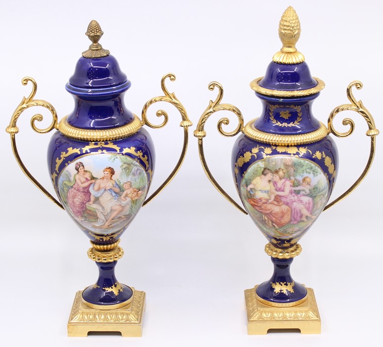 Two continental twin-handled pedestal vases, transfer printed scene, gilt metal mounts, pineapple