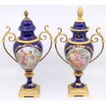 Two continental twin-handled pedestal vases, transfer printed scene, gilt metal mounts, pineapple