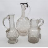 A 19th century etched glass ewer and cover, etched with animals; and two jugs (3)