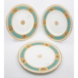 A set of six dessert plates, gilt borders with vignettes painted with flowers, central gilt