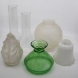 A collection of assorted glass oil lamp shades and funnels