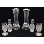 A pair of silver mounted cut glass vases; a pair of cut glass vases with filled silver bases; a pair