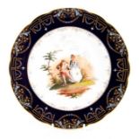 A Continental cabinet plate, painted with a scene of two figures, gilt and enamel border
