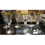 A pair of Edwardian glass ewers, gilt line detail; and a set of six wine glasses (8)