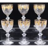 A set of six faceted crystal wine glasses, gilt vine decoration, hexagonal bases (6)