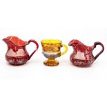 A pair of etched ruby flash glass jugs; and an amber glass mug (3)