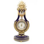 A 20th century porcelain mantel clock with gilt metal mounts