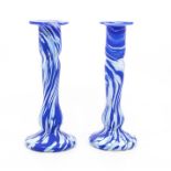 A pair of blue and white glass candlesticks, swirl decoration