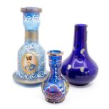 Three blue glass bottles, one painted with a portrait of a gentleman (3)