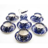 Six blue and white cups and saucers, and a jug