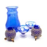 A pair of blue flash glass dessert dishes; a pair of gilt blue glass vases; and a tall blue glass